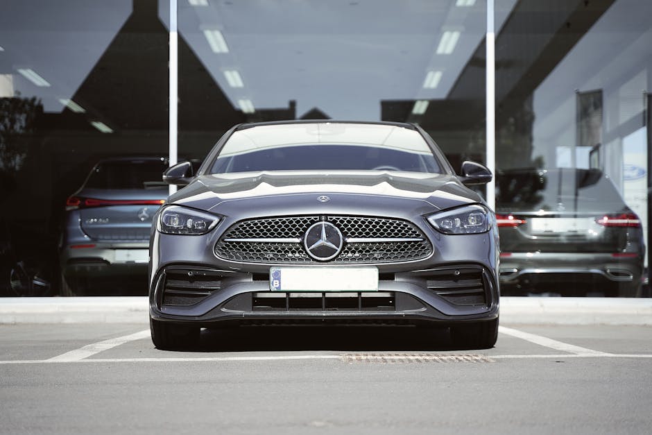 Front view of a sleek gray Mercedes-Benz sports car parked at an auto dealership